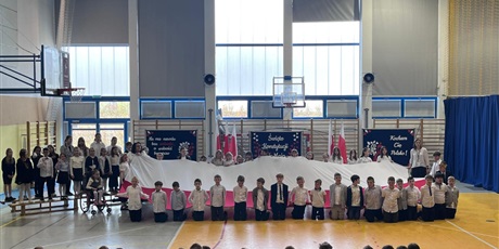 Powiększ grafikę: Uczniowie klas 2d i 3d prezetują flagę Polski publiczności. 