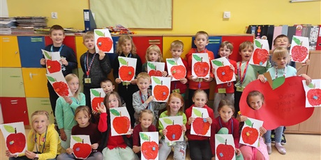 Powiększ grafikę: Dzieci pozują z wykonanymi przez siebie jabłuszkami. 